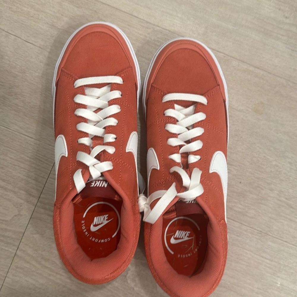 Nike women red and white shoes.